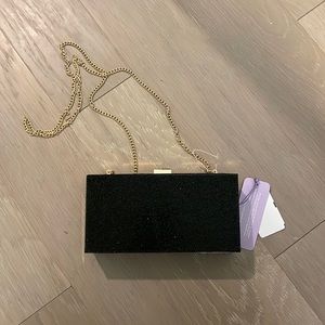 NWT black rhinestone rectangular clutch with gold chain. Brand is: Jill & Ally